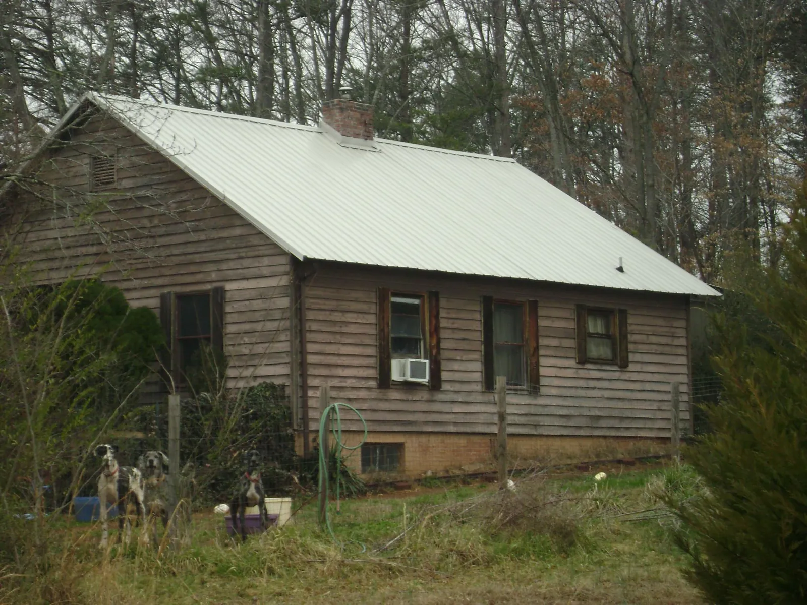 White metal roof on an old wood sided farmhouse, from a Metal Roof Installation job in Roann